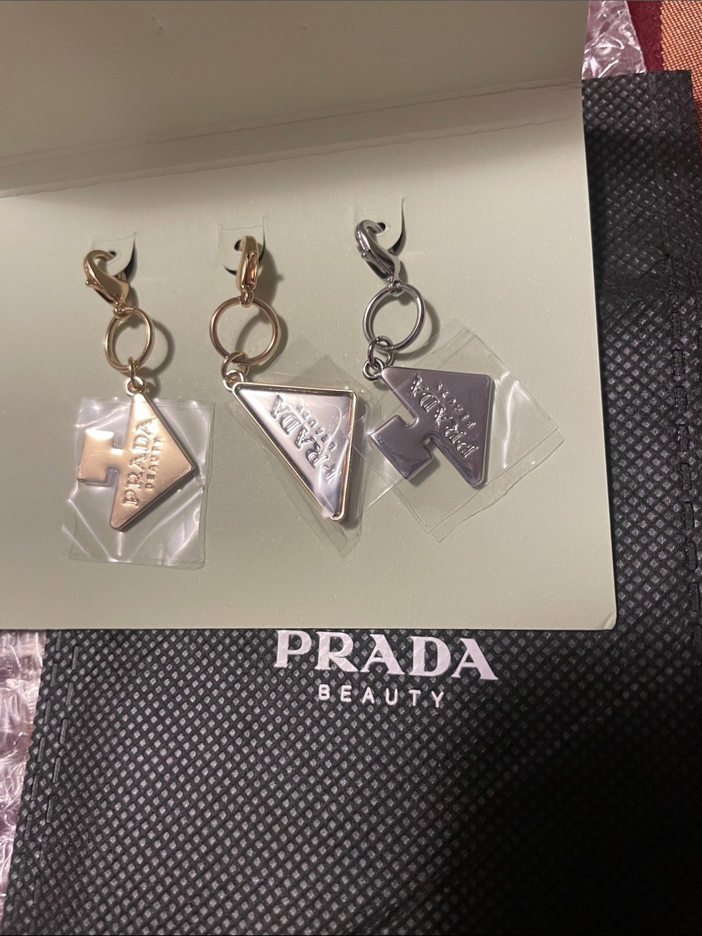 Prada Triangular Logo Charms in Gold & Silver Tones